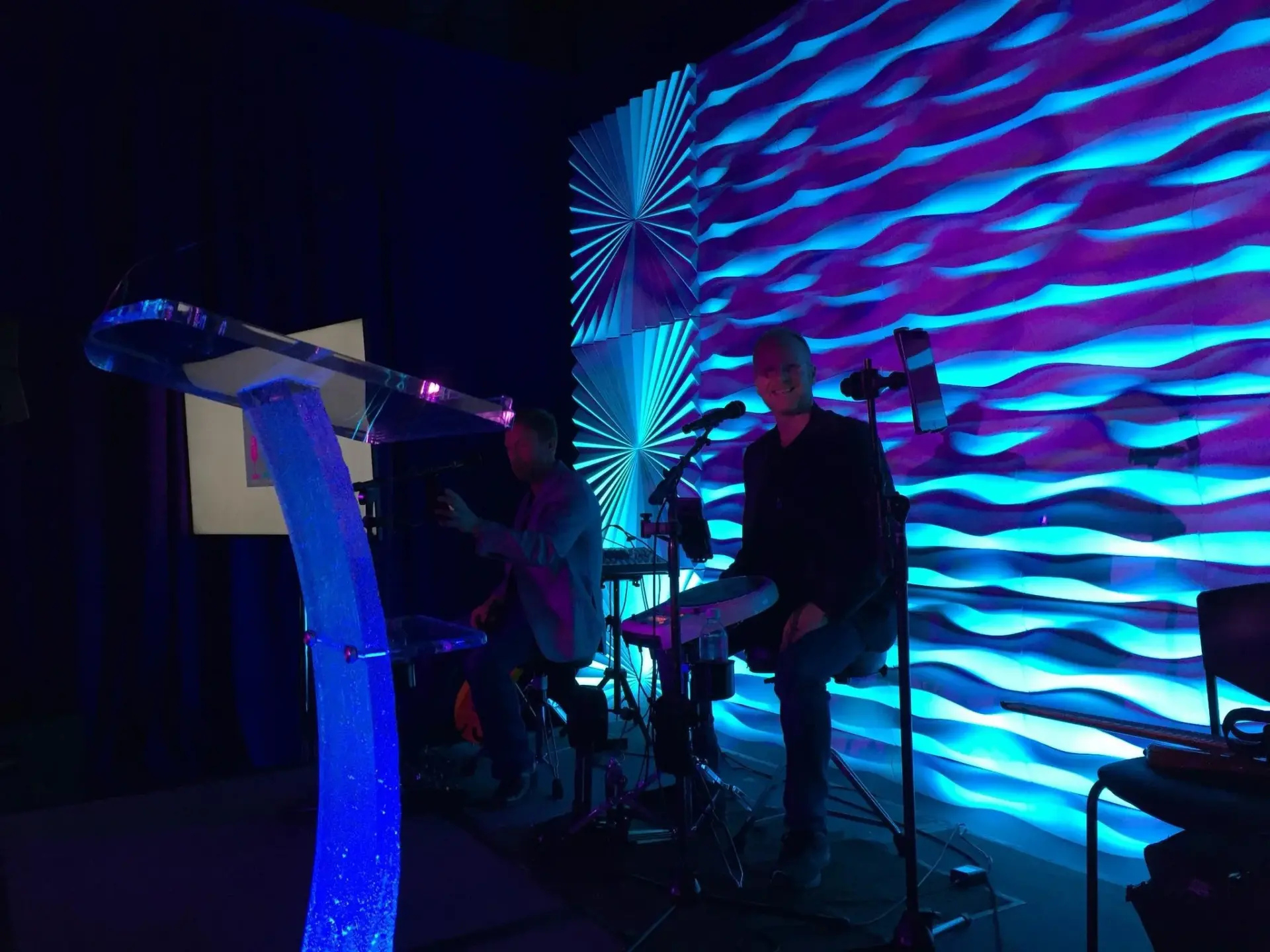 77th Street Revue performing in front of blue lighting